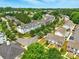 Expansive aerial view of the neighborhood showcasing well-maintained homes, green trees, and streetscapes at 1134 Plaza Walk Dr, Charlotte, NC 28215