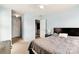 A bright bedroom features a cozy bed with neutral bedding, complementing the light blue walls and carpet at 1134 Plaza Walk Dr, Charlotte, NC 28215