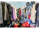 Walk-in closet with organized hanging clothes, shelving and neatly arranged shoe boxes at 1134 Plaza Walk Dr, Charlotte, NC 28215