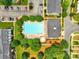 Aerial view highlighting a community pool with lounge chairs and lush green spaces, perfect for relaxing at 1134 Plaza Walk Dr, Charlotte, NC 28215