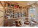 Opulent home bar featuring custom woodwork, glass shelving, and rich textures for an inviting space at 1172 Queens Rd, Charlotte, NC 28207