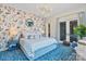 Stylish bedroom with floral wallpaper, modern lighting, and a plush bed with patterned rug at 1172 Queens Rd, Charlotte, NC 28207