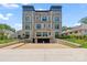 Luxury building featuring a private parking garage and well-manicured landscaping at 1172 Queens Rd, Charlotte, NC 28207