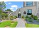 Beautifully landscaped front entrance with stone pathway and manicured bushes at 1172 Queens Rd, Charlotte, NC 28207