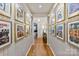 Unique hallway featuring framed Beatles posters and gleaming hardwood floors at 1172 Queens Rd, Charlotte, NC 28207