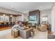 Open-concept living room featuring a fireplace, piano, and seamless transition to the kitchen at 1172 Queens Rd, Charlotte, NC 28207