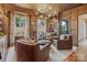 Elegant living room with leather seating, custom bar, and stylish decor for sophisticated living at 1172 Queens Rd, Charlotte, NC 28207