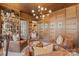 An elegant living room featuring leather seating, custom woodwork, and a well-appointed bar area at 1172 Queens Rd, Charlotte, NC 28207