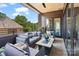 This covered patio offers comfortable outdoor living with plush seating and scenic views at 1172 Queens Rd, Charlotte, NC 28207