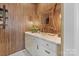 A stylish powder room has textured wallpaper, a decorative mirror, and a marble countertop at 1172 Queens Rd, Charlotte, NC 28207