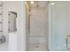 Walk-in shower with marble surround, built-in bench and gold shower head at 1172 Queens Rd, Charlotte, NC 28207