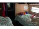 Bedroom featuring two twin beds with patterned bedding and natural lighting at 120 Starboard Trl, Mount Gilead, NC 27306