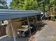 Carport with a covered golf cart, providing secure parking and shade at 120 Starboard Trl, Mount Gilead, NC 27306