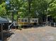 Cozy cabin surrounded by lush trees and greenery, offering a peaceful retreat at 120 Starboard Trl, Mount Gilead, NC 27306