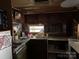 Functional kitchen with dark wood cabinets and essential appliances at 120 Starboard Trl, Mount Gilead, NC 27306