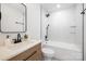 Modern bathroom featuring wood vanity, white marble tile, black hardware, and combined tub and shower at 12013 Dolomite Dr, Pineville, NC 28134