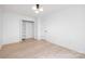 Bright bedroom features neutral paint, hardwood floors, a modern ceiling light, and closet at 12013 Dolomite Dr, Pineville, NC 28134