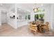 Open-concept dining and kitchen area with light wood floors and lots of natural light at 12013 Dolomite Dr, Pineville, NC 28134