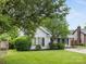 Inviting single-story house with a gray exterior, black shutters, and manicured front yard at 12013 Dolomite Dr, Pineville, NC 28134