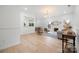Open-concept living room with neutral paint, hardwood floors, fireplace, and ample natural light at 12013 Dolomite Dr, Pineville, NC 28134