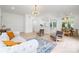 Open-concept living room and dining area with light wood floors and bright white walls at 12013 Dolomite Dr, Pineville, NC 28134