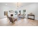 Bright living room featuring a fireplace, light wood floors, and a stylish gray sofa at 12013 Dolomite Dr, Pineville, NC 28134
