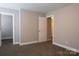 Bedroom featuring neutral walls, carpet, and white trim throughout at 12150 Plover Dr, Charlotte, NC 28269