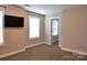 Empty bedroom with neutral walls and carpet; large windows provide natural light at 12150 Plover Dr, Charlotte, NC 28269