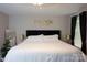 Bright bedroom with a king bed, gold accents and a large window at 12150 Plover Dr, Charlotte, NC 28269