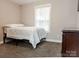 Well-lit bedroom features carpet, neutral walls, and a lovely window at 12150 Plover Dr, Charlotte, NC 28269