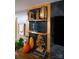 Close up of built-in shelving with wooden trim, herringbone background, and decor at 12150 Plover Dr, Charlotte, NC 28269