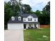 Charming two-story home with well-manicured lawn, covered porch, and attached two-car garage at 12150 Plover Dr, Charlotte, NC 28269