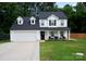 Attractive two-story home with an attached garage, covered front porch and a well-kept lawn at 12150 Plover Dr, Charlotte, NC 28269