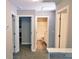 Upstairs hallway with multiple rooms and neutral carpeting at 12150 Plover Dr, Charlotte, NC 28269