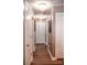Hallway with hardwood floors and elegant lighting fixtures at 12150 Plover Dr, Charlotte, NC 28269