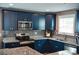 Contemporary kitchen featuring blue cabinets, granite countertops, and stainless steel appliances at 12150 Plover Dr, Charlotte, NC 28269