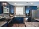 Modern kitchen with blue cabinets, stainless steel appliances, and granite countertops at 12150 Plover Dr, Charlotte, NC 28269
