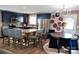 Kitchen features an island, stainless steel appliances, and dining area with blue velvet chairs at 12150 Plover Dr, Charlotte, NC 28269