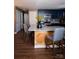 Kitchen boasts a large island with stone countertops, blue cabinets, and wood paneled accents at 12150 Plover Dr, Charlotte, NC 28269