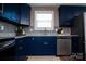 Bright kitchen features navy cabinets, granite countertops, stainless steel appliances, and stylish backsplash at 12150 Plover Dr, Charlotte, NC 28269
