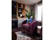 Plush purple chair is perfectly placed next to custom shelves in this living room at 12150 Plover Dr, Charlotte, NC 28269