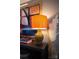 Side table with a decorative lamp, art and vase at 12150 Plover Dr, Charlotte, NC 28269