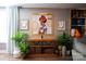 Stylish console table with decor beneath a framed art piece, enhanced by plants and storage baskets at 12150 Plover Dr, Charlotte, NC 28269