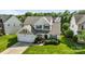 Two-story home featuring a well-manicured lawn, attached garage, and inviting front porch at 12312 Mcallister Park Dr, Charlotte, NC 28277