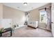 Bright bedroom with a crib, carpeted floor, and a window with decorative curtains at 12312 Mcallister Park Dr, Charlotte, NC 28277