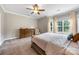 Well-lit bedroom with a large window, ceiling fan, and neutral carpet at 12312 Mcallister Park Dr, Charlotte, NC 28277