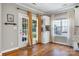 Bright dining area with hardwood floors, a door to backyard, and stylish curtains at 12312 Mcallister Park Dr, Charlotte, NC 28277