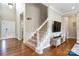Inviting entryway with hardwood floors, a staircase, and a modern television at 12312 Mcallister Park Dr, Charlotte, NC 28277