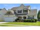 Charming two-story home featuring a well-manicured lawn, attached garage, and inviting front porch at 12312 Mcallister Park Dr, Charlotte, NC 28277