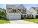 Charming two-story home featuring a well-manicured lawn, attached garage, and inviting front porch at 12312 Mcallister Park Dr, Charlotte, NC 28277